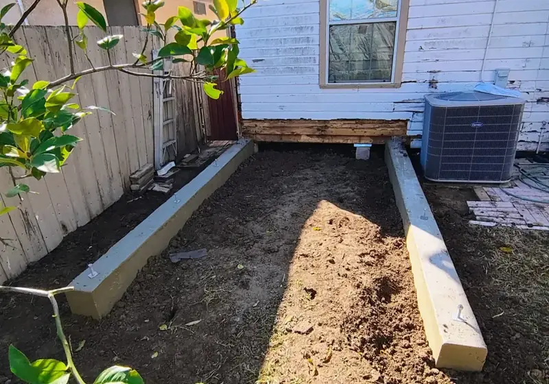 Freshly poured concrete footing and beam forms for a room addition on an RGV home